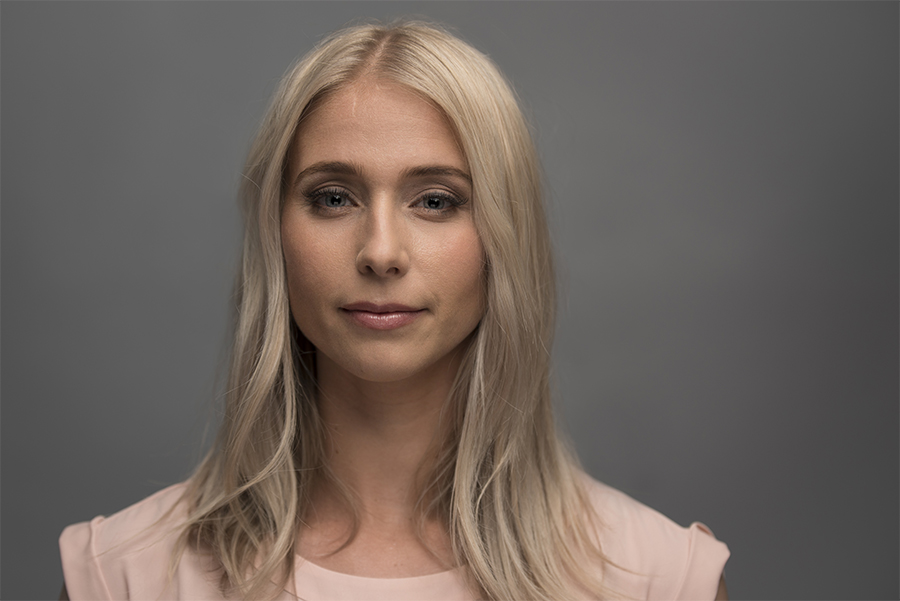 Studio headshot portrait against a gray backdrop